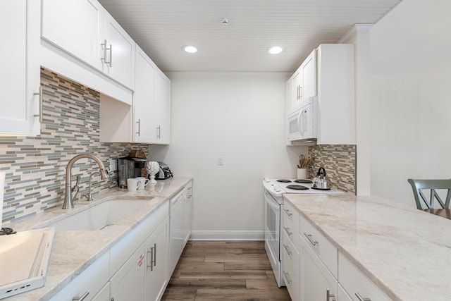 kitchen with sink, white appliances, white cabinetry, dark hardwood / wood-style floors, and light stone counters