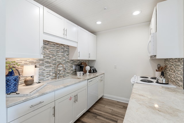 kitchen with white appliances, sink, and white cabinets