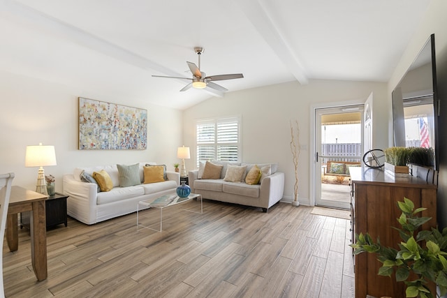 living room featuring lofted ceiling with beams, ceiling fan, and light wood-type flooring