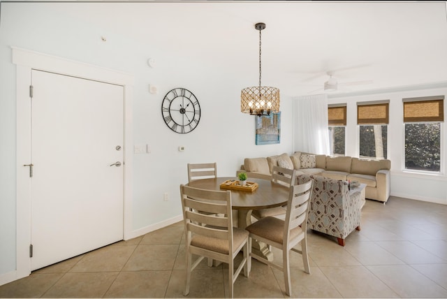 dining area featuring light tile patterned flooring and ceiling fan with notable chandelier