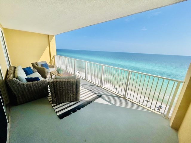 balcony with a water view and a beach view