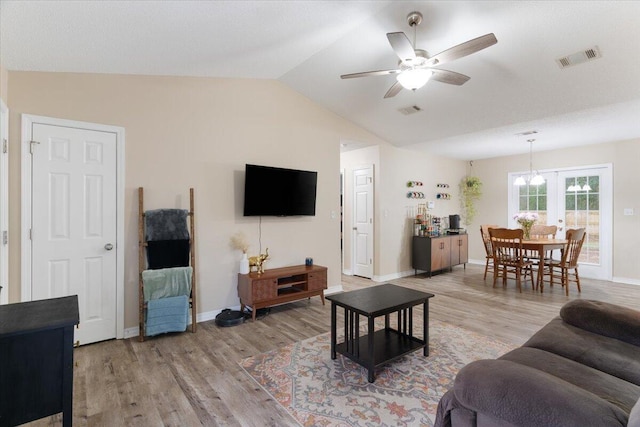 living room featuring ceiling fan, french doors, light hardwood / wood-style floors, and lofted ceiling