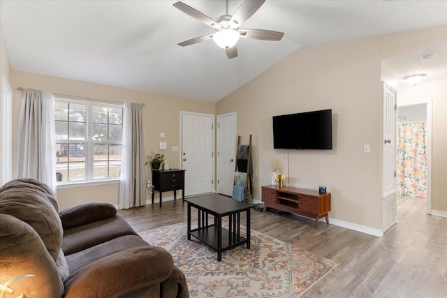 living room featuring light hardwood / wood-style flooring, ceiling fan, and lofted ceiling