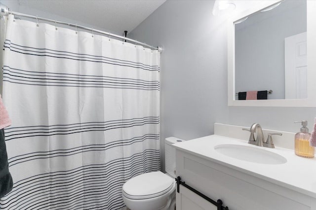 bathroom with vanity, a shower with curtain, a textured ceiling, and toilet