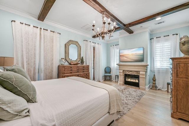 bedroom featuring multiple windows, light hardwood / wood-style flooring, beamed ceiling, and an inviting chandelier