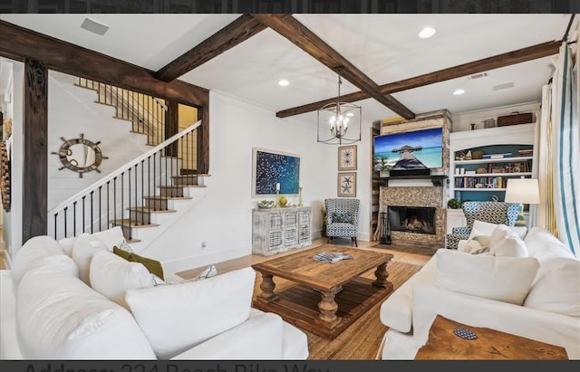 living room with hardwood / wood-style floors, a notable chandelier, beam ceiling, and built in features