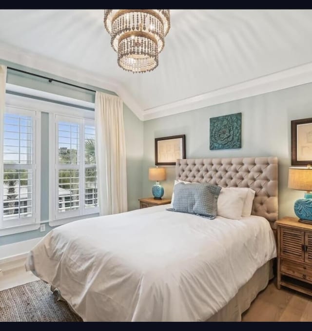 bedroom featuring hardwood / wood-style floors and a notable chandelier