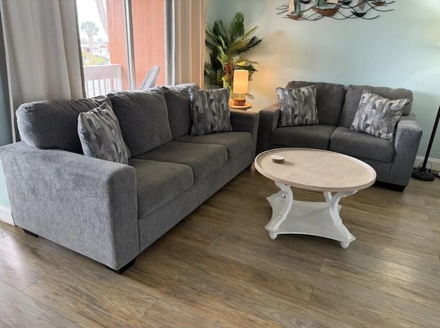 living room with hardwood / wood-style flooring and a notable chandelier