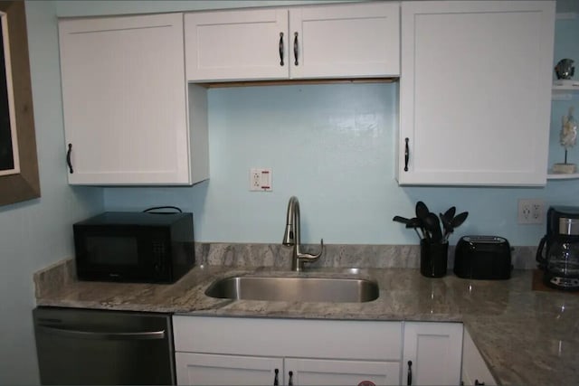 kitchen with white cabinetry, sink, and black appliances