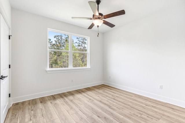 363 Bear Creek Blvd, Freeport, FL 32439 - spare room with baseboards, light wood-type flooring, and ceiling fan