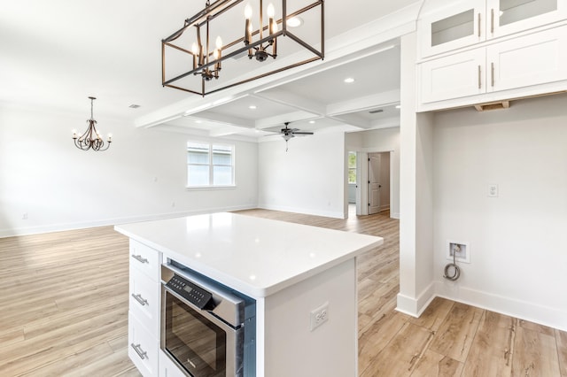 363 Bear Creek Blvd, Freeport, FL 32439 - kitchen with coffered ceiling, beam ceiling, light wood-style floors, built in microwave, and white cabinets