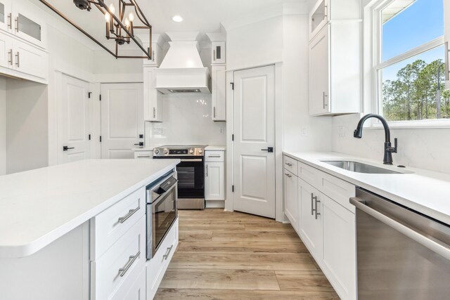 363 Bear Creek Blvd, Freeport, FL 32439 - kitchen featuring decorative backsplash, light countertops, stainless steel appliances, premium range hood, and a sink