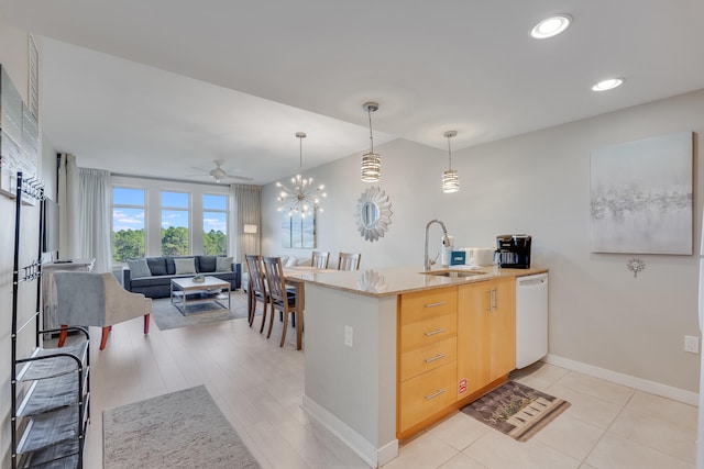 kitchen featuring light brown cabinets, white dishwasher, ceiling fan with notable chandelier, sink, and kitchen peninsula