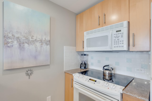 kitchen with decorative backsplash, light brown cabinets, and white appliances