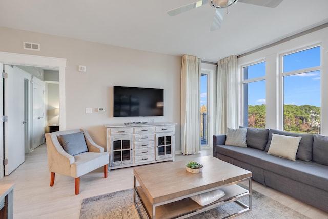 living room with ceiling fan and light hardwood / wood-style floors