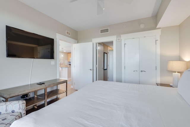 bedroom with ceiling fan and a closet