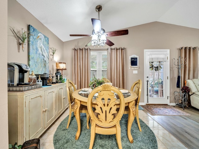 dining space with ceiling fan, light hardwood / wood-style floors, and lofted ceiling