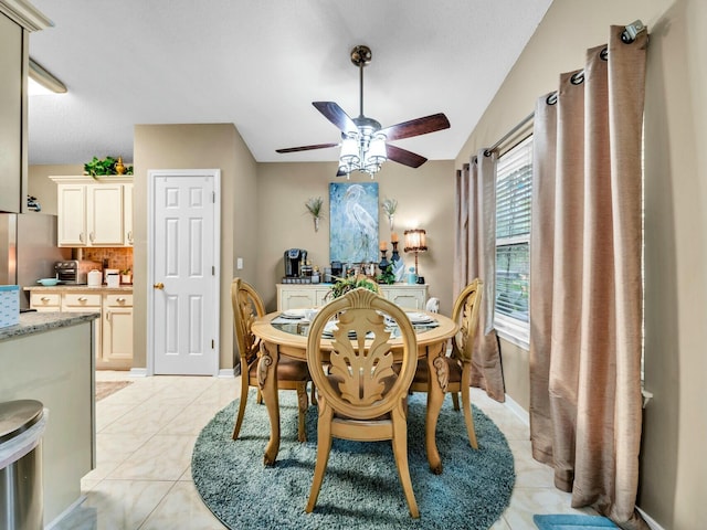 dining area with ceiling fan and light tile patterned floors