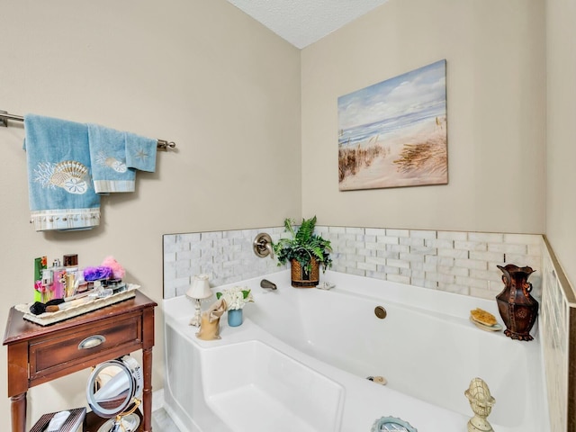 bathroom featuring a bathing tub and a textured ceiling