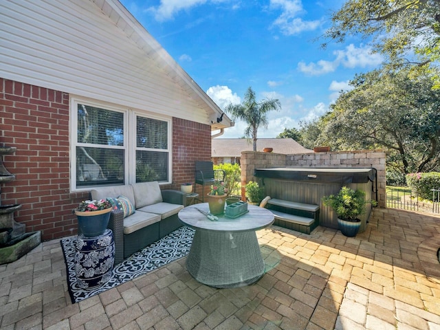 view of patio / terrace with outdoor lounge area and a hot tub