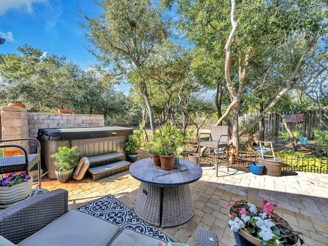 view of patio / terrace with a hot tub