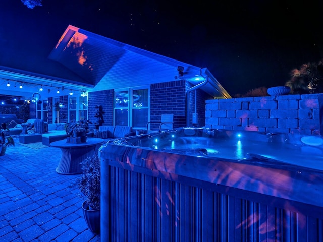 patio at night with a hot tub