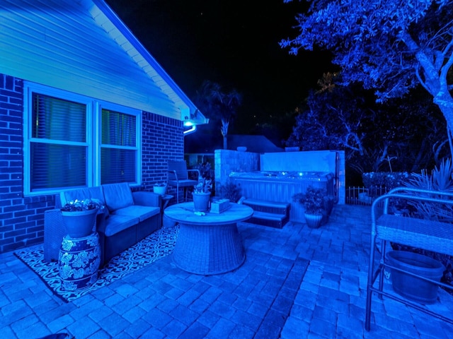 patio at night featuring an outdoor hangout area