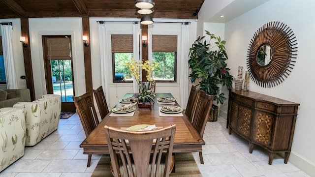 dining room with beamed ceiling and light tile patterned floors