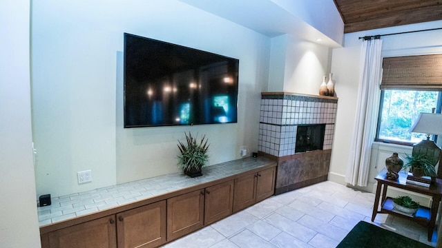 living room with wooden ceiling, lofted ceiling, and light tile patterned flooring