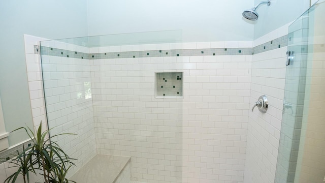 bathroom with a tile shower