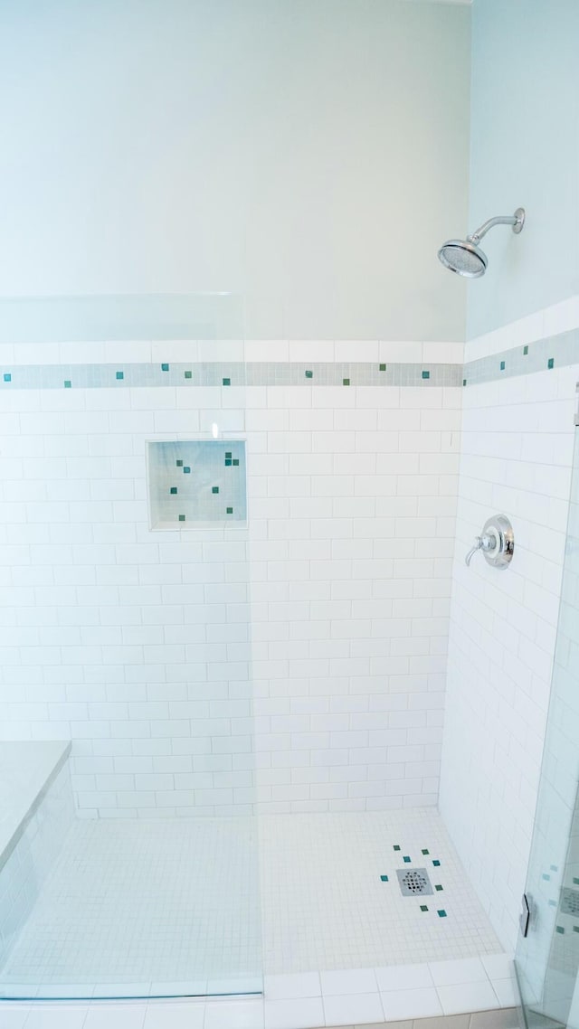 bathroom with tiled shower