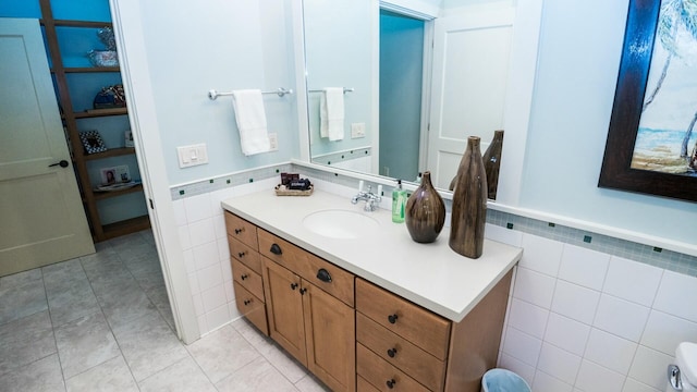 bathroom featuring vanity and tile walls