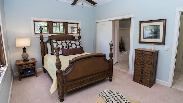 carpeted bedroom with ceiling fan and a closet