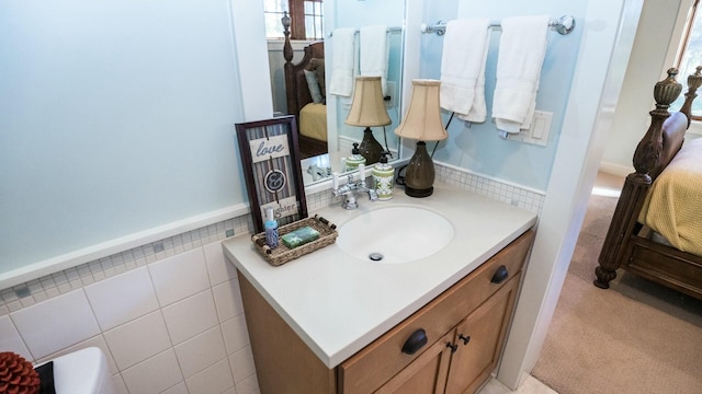 bathroom featuring vanity and tile walls