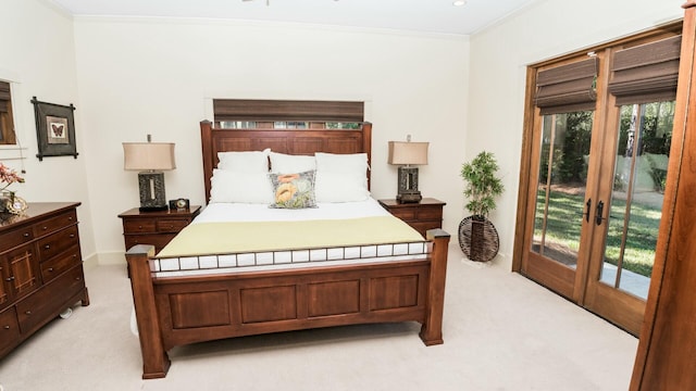 carpeted bedroom with ornamental molding, access to outside, and french doors