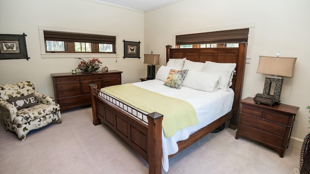 bedroom with multiple windows, crown molding, and light colored carpet