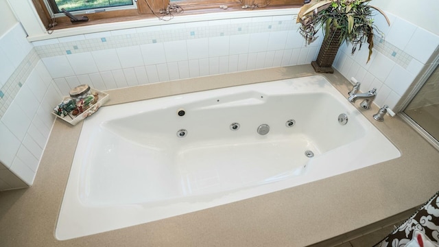 bathroom with a tub to relax in