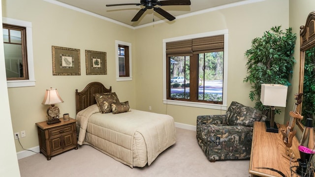 carpeted bedroom with ceiling fan and crown molding