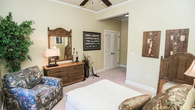 bedroom featuring a closet, ceiling fan, crown molding, and light carpet