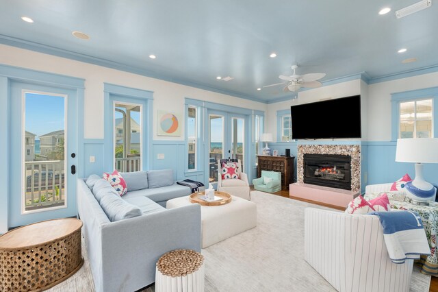 living room with ceiling fan, crown molding, and french doors