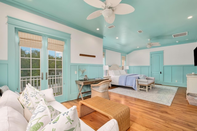 bedroom featuring access to exterior, french doors, light wood-type flooring, and ceiling fan