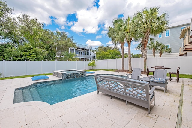 view of pool featuring a patio area and an in ground hot tub