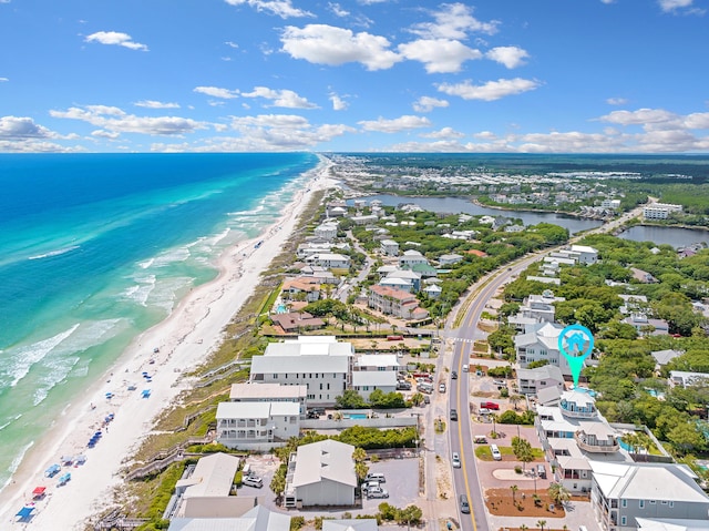 bird's eye view featuring a water view and a beach view