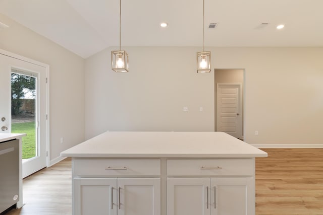 kitchen with lofted ceiling, light hardwood / wood-style flooring, white cabinetry, and pendant lighting