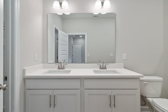 bathroom with toilet and vanity