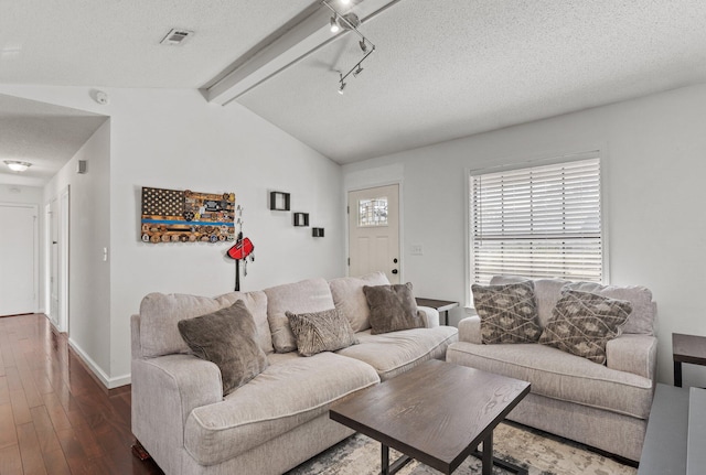 living room featuring dark hardwood / wood-style floors, lofted ceiling with beams, and a textured ceiling