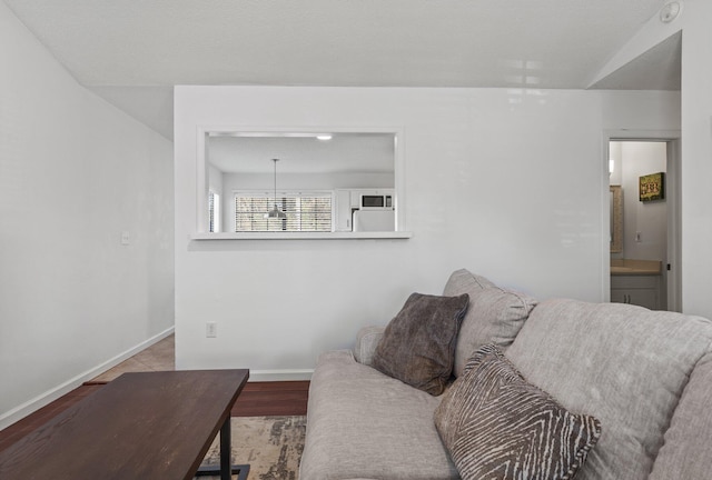 living room featuring vaulted ceiling and light hardwood / wood-style floors