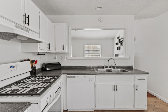 kitchen featuring white cabinetry, sink, a textured ceiling, and white appliances