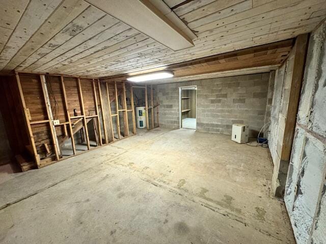 unfinished attic featuring electric water heater