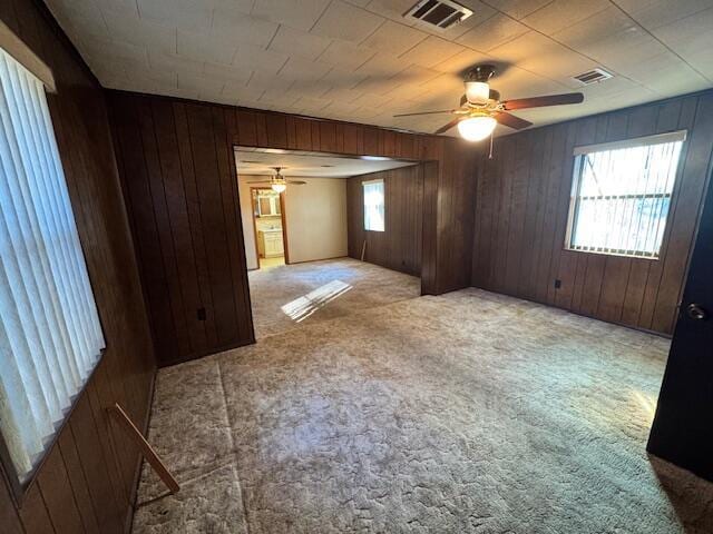 carpeted spare room with ceiling fan